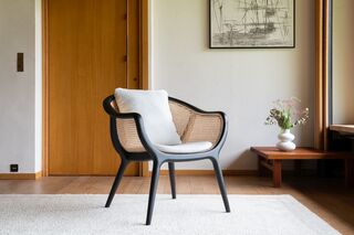 Black armchair in solid ash and wicker