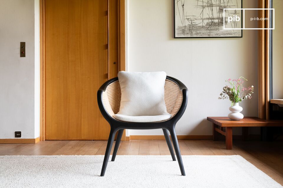 This black solid ash armchair features a curvaceous design, accentuated by its multiple curves